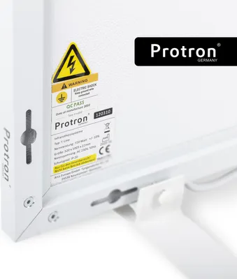 A close-up view of the side and back of a white Protron infrared heating panel, showing labels and mounting hardware.