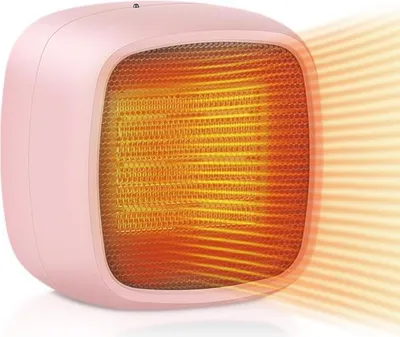 A pink mini electric ceramic heater emitting warm air.