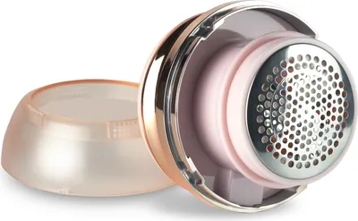 A close-up, angled view of a fabric shaver with its protective cap removed, showing the metallic cutting head and internal components.