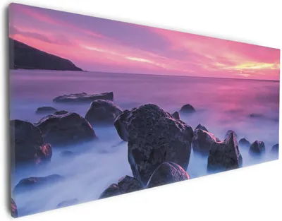 Produktbild von Wallario Premium Leinwandbild Felsen im Meer bei Sonnenuntergang in Größe 30 x 75 cm