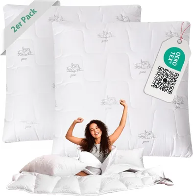 A woman is stretching in bed, surrounded by pillows and duvets, with product packaging visible.