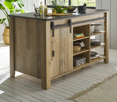 A kitchen island with a sliding barn door and open shelving, set in a bright, modern kitchen with plants and natural light.