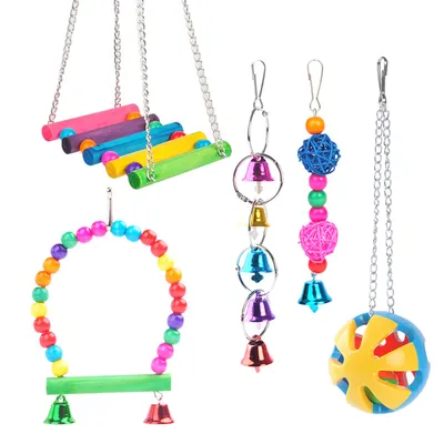 A collection of colorful bird toys, including swings, bells, and balls, arranged on a white background.