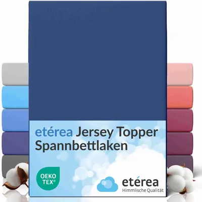 A stack of folded fitted sheets in various colors, with the main product in navy blue prominently displayed.