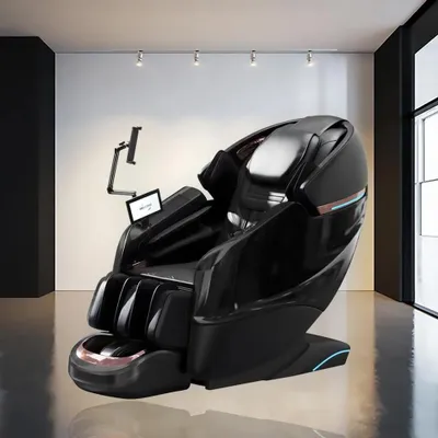 A high-end black massage chair is displayed in a modern, minimalist room with white walls and track lighting.