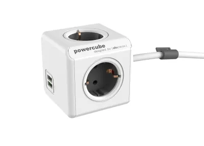 A white PowerCube with two outlets and two USB ports, connected to a white cable with a gray clip.