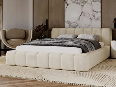A bedroom scene with a bed, chair, and artwork.
