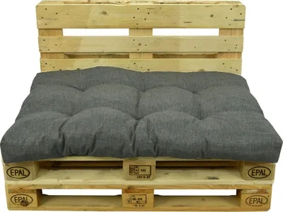 A gray cushion set on a wooden pallet.