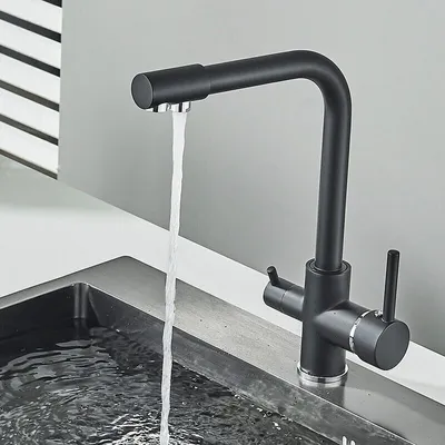 A black kitchen faucet with water running into a sink.