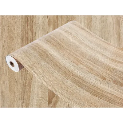 A roll of wood-effect contact paper against a background of the same pattern.