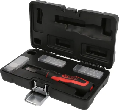 A black plastic case containing a set of tools, including a screwdriver with a red and black handle and several small plastic containers with blades.