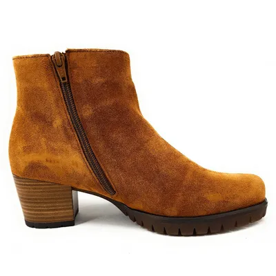 A side view of a brown suede ankle boot with a zipper closure and a block heel.