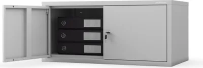 A gray metal filing cabinet with its left door open, revealing three black binders inside. The right side has a sliding door with a lock.