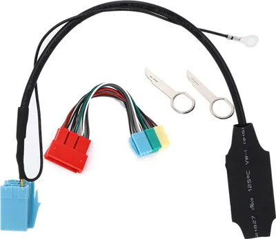 A car audio adapter cable with multiple connectors and two small metal tools.