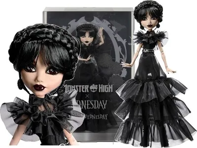 A Monster High doll dressed in a black gothic gown, with a box in the background.