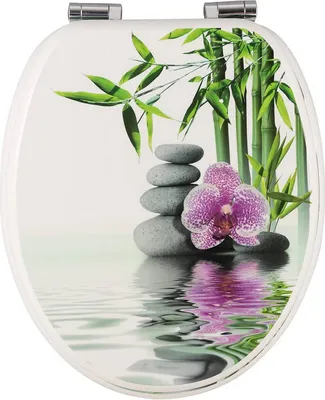 A toilet seat with a decorative design of bamboo, stacked stones, and an orchid, reflected in water.