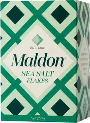 A box of Maldon Sea Salt Flakes with a green geometric pattern.