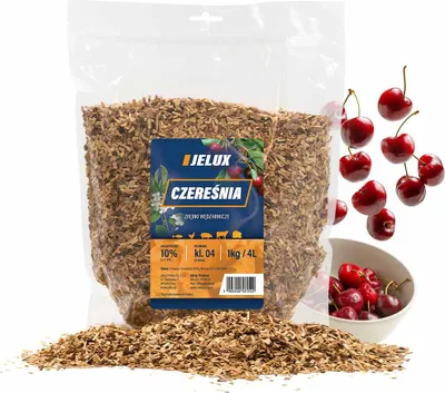 A bag of wood chips with cherries scattered around it.