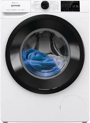 A front-facing studio shot of a white washing machine with a black door rim. Blue laundry is visible inside the drum.