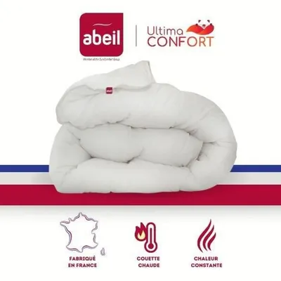 A white duvet is folded and displayed against a white background, with brand logos and feature icons at the top and bottom.