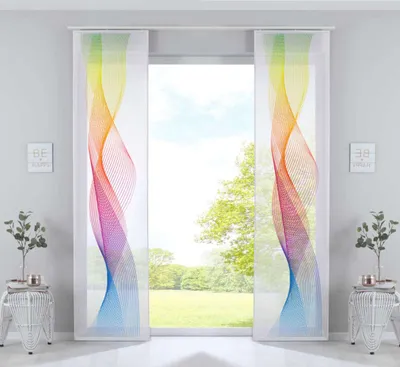 Two panel curtains with a rainbow wave pattern are displayed in front of a window with a view of trees and sky.