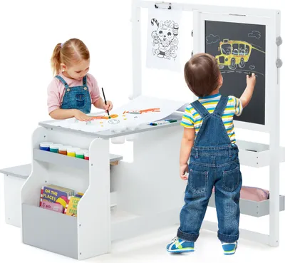 Two children are using a multi-functional art easel and desk set.
