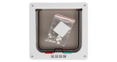 A white pet door with a clear flap and a small bag of hardware inside.