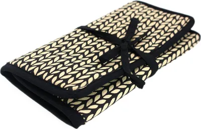 A closed roll-up case for knitting needles, tied with a black ribbon.