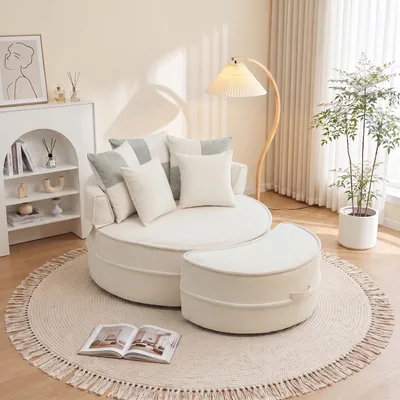 Imagen del producto de Sofá redondo con 5 cojines y un reposapiés, ideal para salones y dormitorios, color beige
