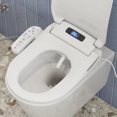 A close-up view of a smart bidet toilet seat with a remote control and a digital display.