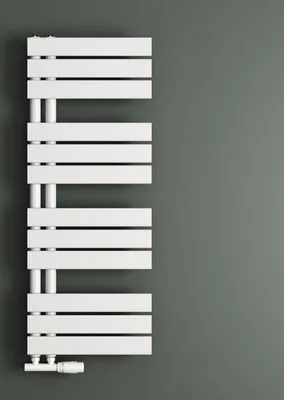 A white radiator against a gray wall.