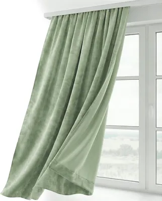 A light green velvet curtain hangs in front of a window.