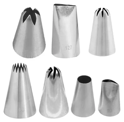 A collection of seven stainless steel piping tips arranged in two rows against a white background.