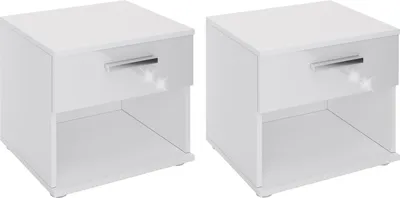 Two white bedside tables with drawers and open shelves against a white background.