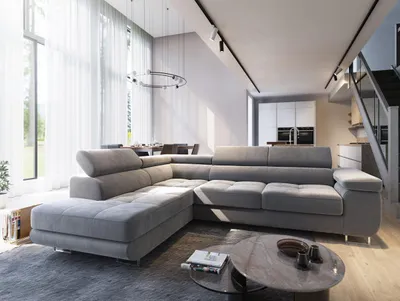 A modern living room with a large sectional sofa, coffee table, and a view of a dining area and kitchen.
