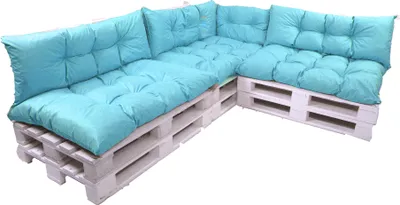 A sectional outdoor sofa made from white painted wooden pallets and topped with light blue cushions.