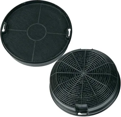 Two charcoal filters for a range hood, one is a flat disc with a grid pattern, the other is a more domed shape with a mesh cover.