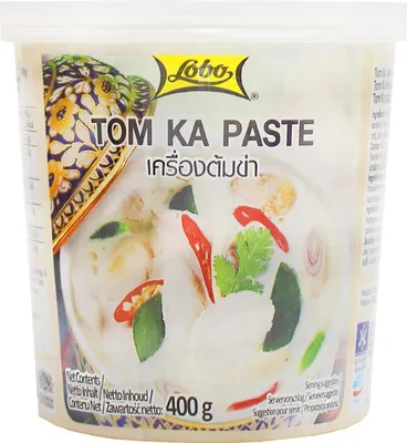 A product shot of a container of Tom Ka Paste.