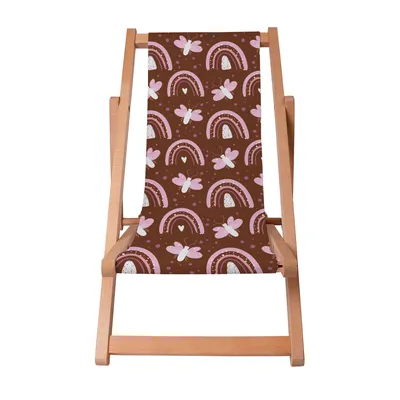 A wooden deck chair with a brown fabric seat featuring a pattern of pink butterflies and rainbows.
