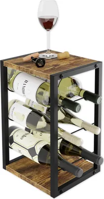 A wine rack filled with wine bottles, with a wine glass on top.