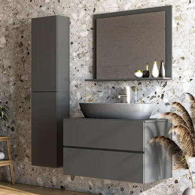 A modern bathroom vanity with a sink, mirror, and storage cabinet, set against a textured stone wall.