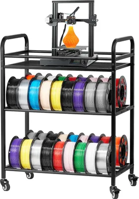 A black three-tiered rolling cart filled with spools of 3D printer filament, with a 3D printer on the top shelf printing an orange object.