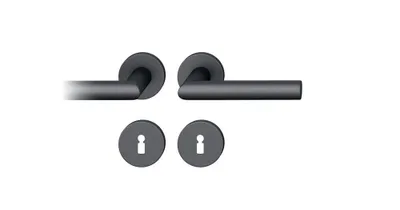 Two door handles and two keyhole escutcheons are shown against a white background.