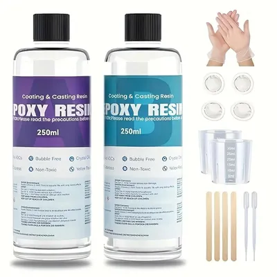 Two bottles of epoxy resin and various accessories for crafting.
