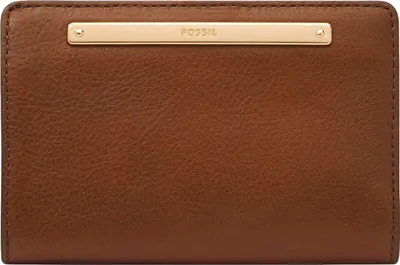 A close-up, front-facing view of a brown leather wallet with a gold-colored metal bar across the top featuring the FOSSIL logo.
