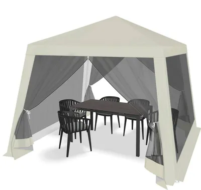 A beige gazebo with mosquito netting, set up with a table and chairs inside.
