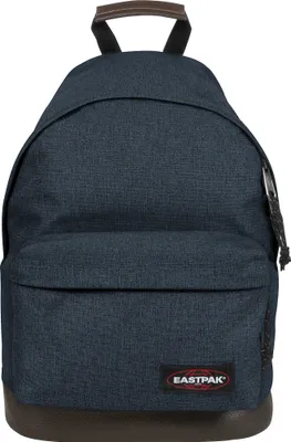 A front view of a blue Eastpak Wyoming rucksack with a brown leather base and handle.