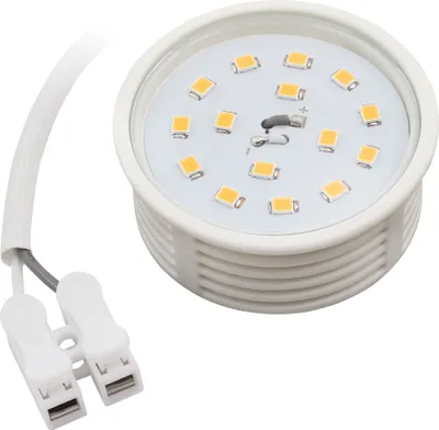 A close-up studio shot of an LED light module with attached wires and connectors.