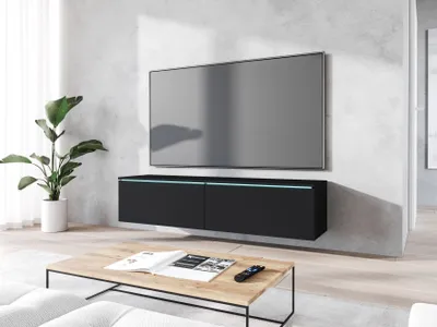 A modern living room with a wall-mounted TV and a black TV cabinet.