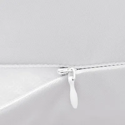 A close-up view of a zipper on a gray fabric product.